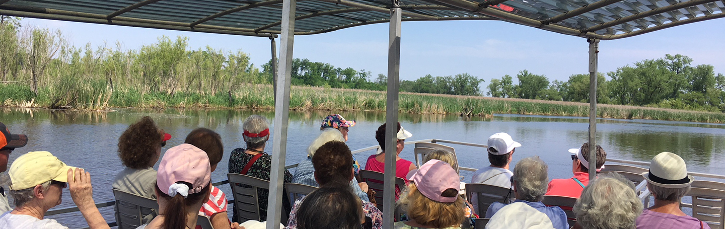 Group of active adults on a boat enjoying the scenery